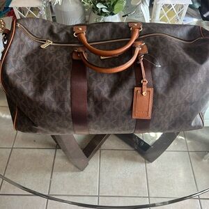 Three piece Michael Kors Signature Brown Duffel, Overnight, and cosmetic bag